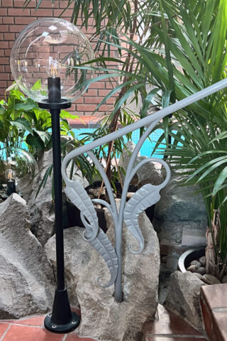 Detail of large form forged leaves painted grey.