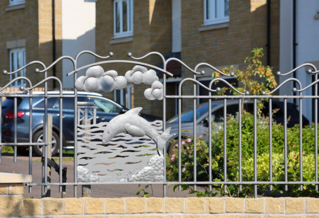 Forged and fabricated panel showing a leaping dolphin.
