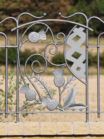 Forged and fabricated decorative metal panel depicting forged thistles and leaves.