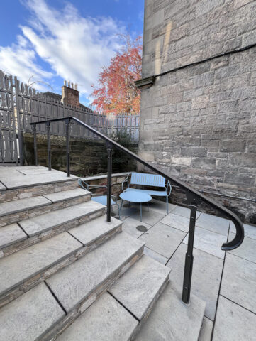Elegant handrail to a flight of seven steps.