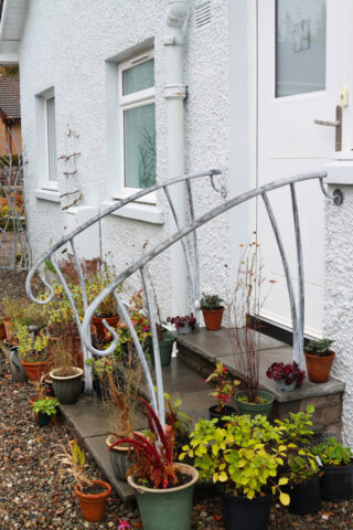 Double handrails to back door steps. Galvanised with an acid etched which gives an organic mottled grey finish.
