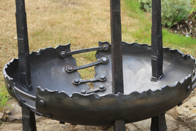 Close up detail showing the textural forging of the steel. Three tall spires intersect through a large sculpted bowl to create a rugged fire pit for the garden. Designed and created by the Ratho Byres Forge artist blacksmith Shona Johnson & Pete Hill.