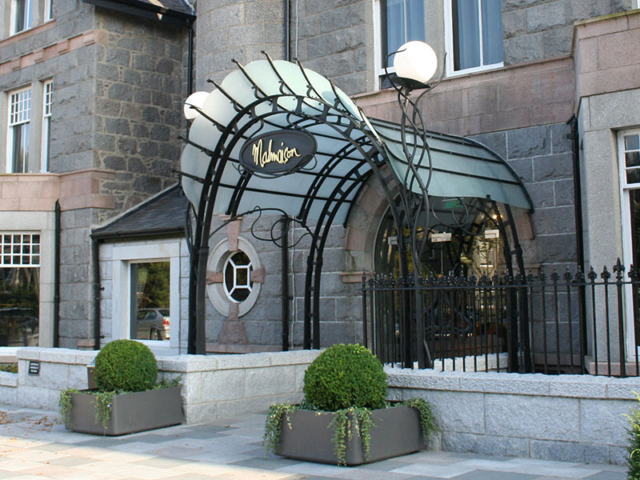 Glazed entrance canopy & sculptural lighting. Malmaison hotel, Aberdeen.